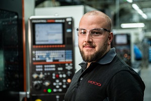 Rob W working at a machine producing Moog components