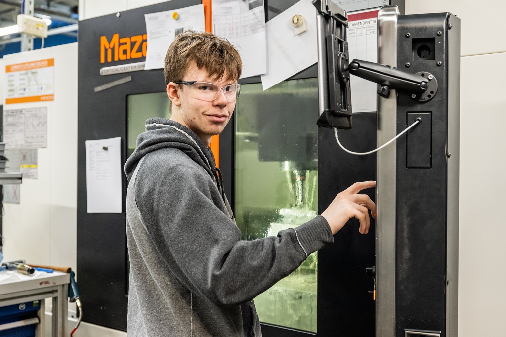 Bert is pictured operating a honing machine to adjust tools accurately
