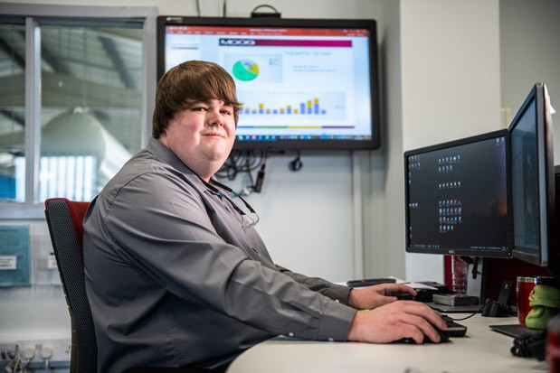 Lead manufacturing engineer David sits at his desk, working on a new project